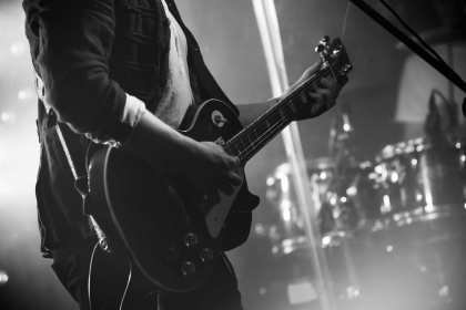 Black and White Image of Man Playing Guitar